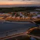 Luchtfoto van Strandpark De Zeeuwse Kust met verlichte tenten bij zonsondergang